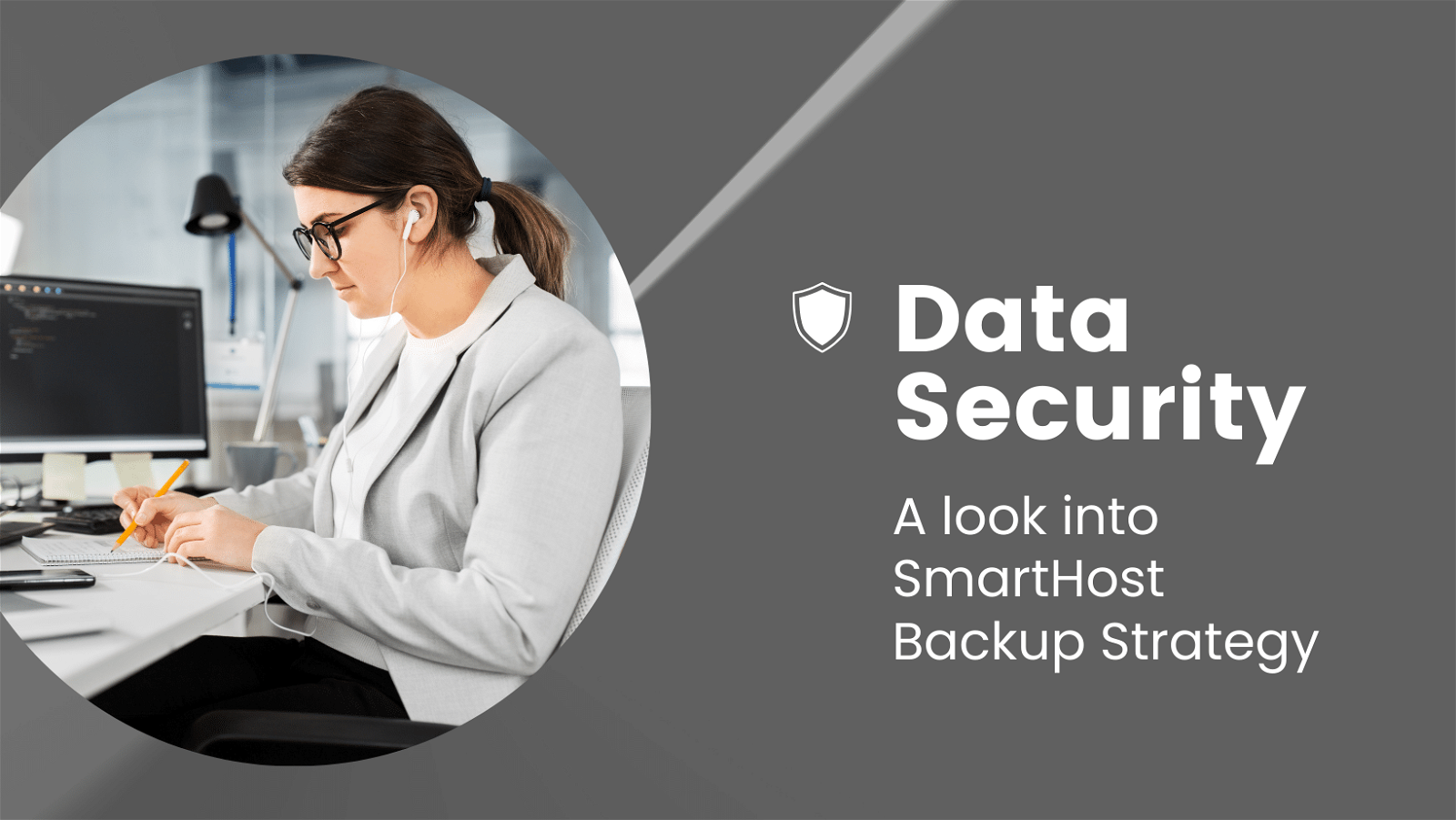 A professional woman reviews documents in a modern office environment, exemplifying data security practices with a focus on SmartHost Backup Strategy.
