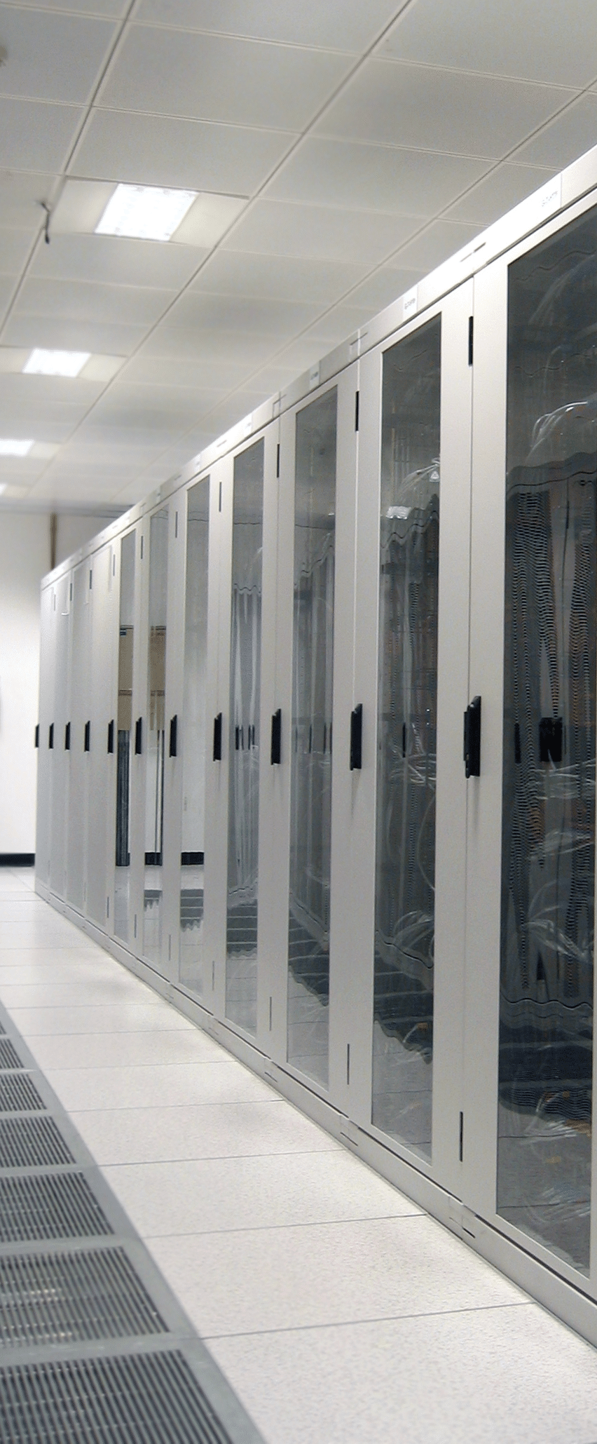 Rows of server cabinets in a web hosting data center with glass doors and cable management visible, under bright overhead lighting.